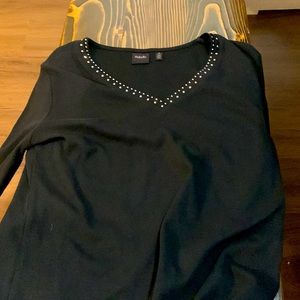 This is a black long sleeve shirt, and has diamond’s all along the neck line